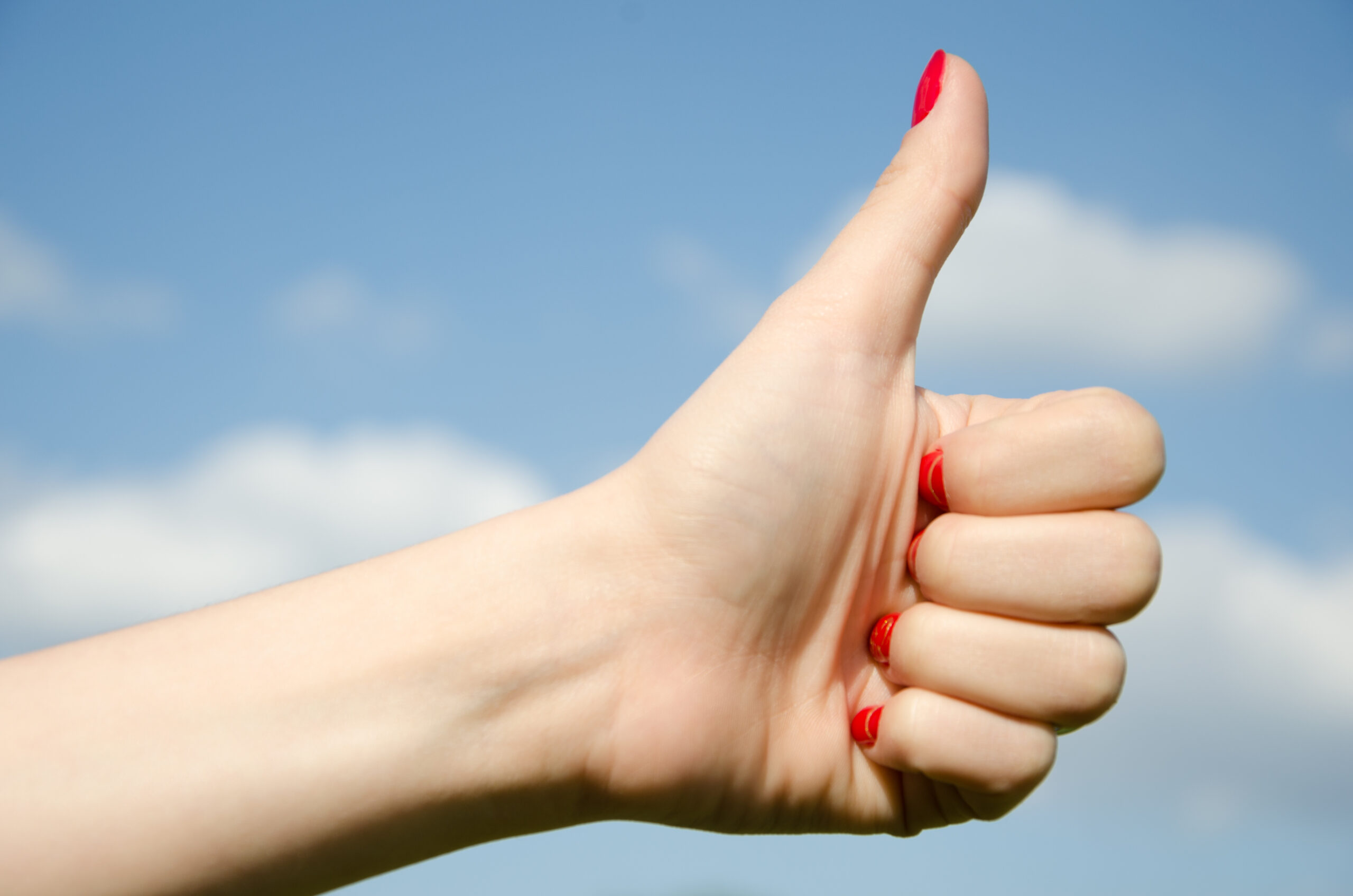 Hand girl showing thumbs up